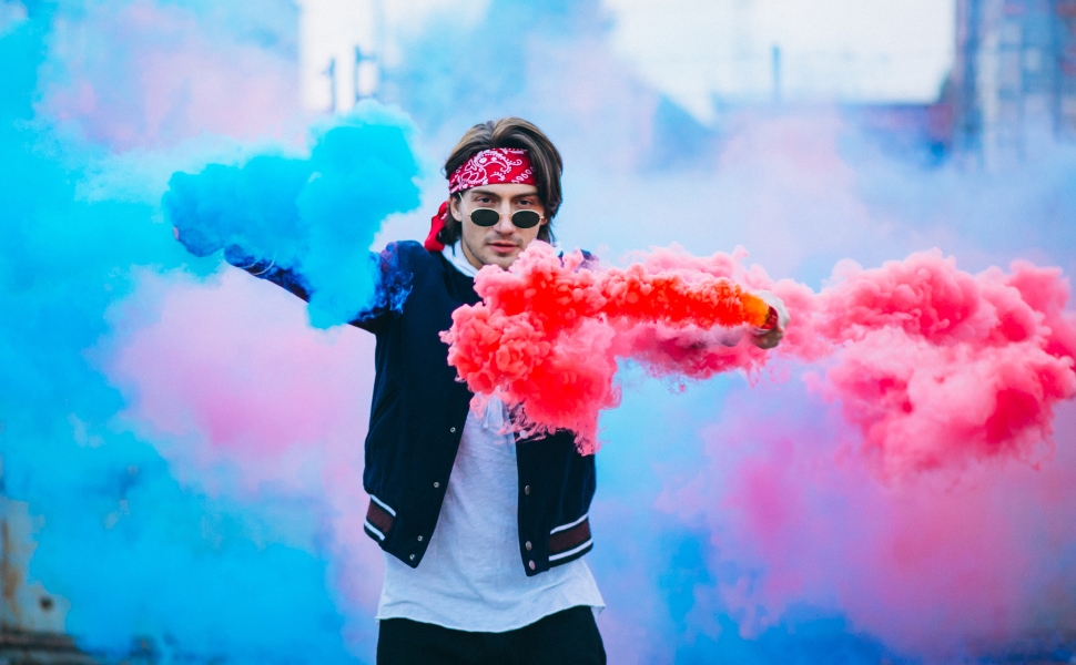 Person holding smoke flare outdoors